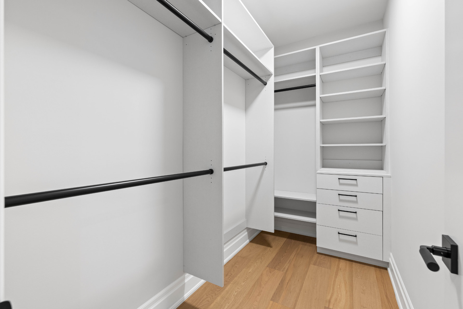 Walk-in closet second view with shelving towers and drawer bank