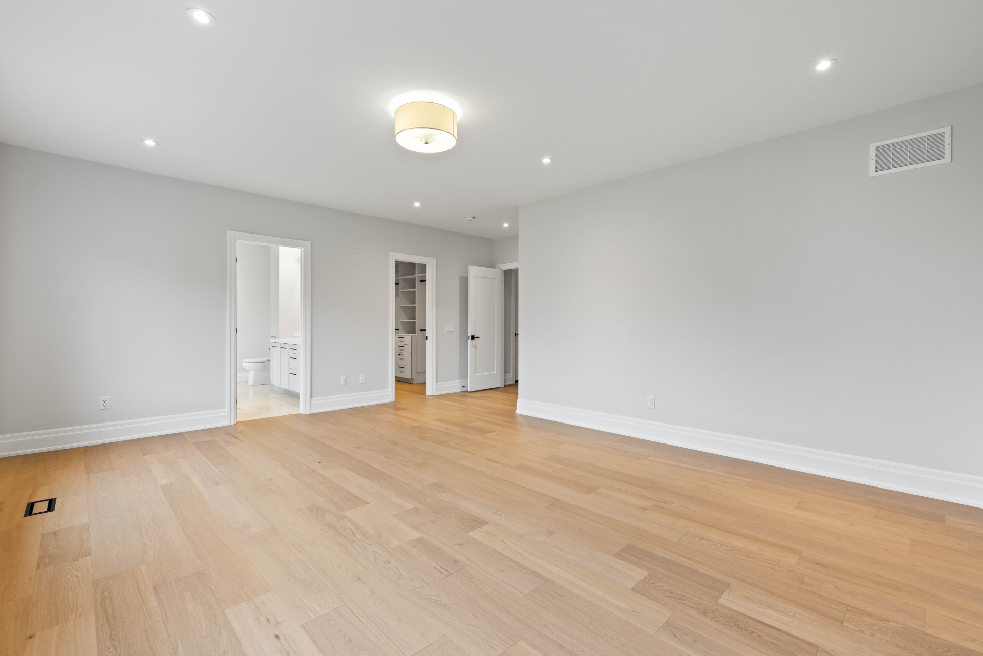Primary bedroom suite with sightlines to the ensuite and walk-in closet